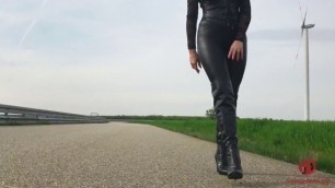 Domina walking outside in leather leggings and high heels boots