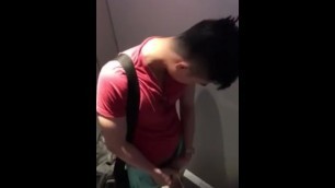 Handsome asian peeing