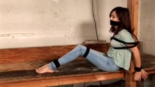 FM — Girl Tied To A Log In Jeans Barefoot