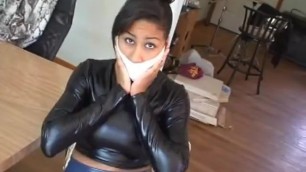 working her mouth under microfoam tape gag in shiny clothes